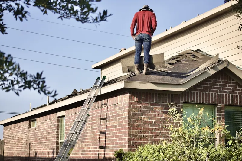 Professional roofer working on a residential roof in Willingboro